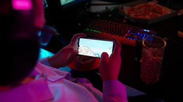 A person playing a game on a smartphone video