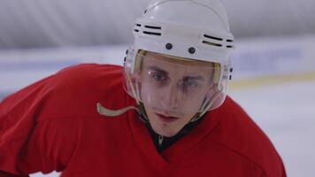 A young man in a red jersey is wearing a helmet video