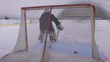 A goalie is standing in front of a net video
