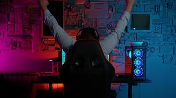 A person sitting at a computer desk with their arms up video