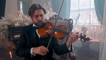 A man in a tuxedo playing the violin video