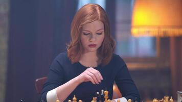 A woman playing chess in a room with a lamp video