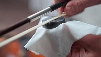 A person is using a pair of scissors to cut a piece of cloth video