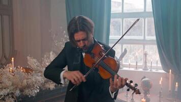 A man in a tuxedo playing the violin video