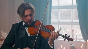 A man in a tuxedo playing the violin video