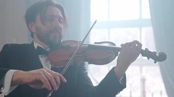 A man in a suit plays the violin video