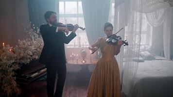 A man and woman in formal attire playing violin video