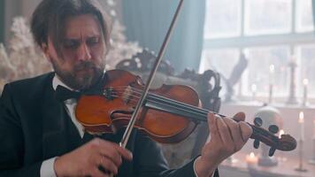 A man in a tuxedo playing the violin video