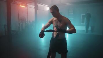 A man is standing in a gym with a rope video