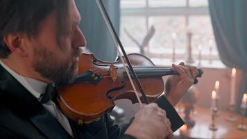 A man in a tuxedo playing the violin video