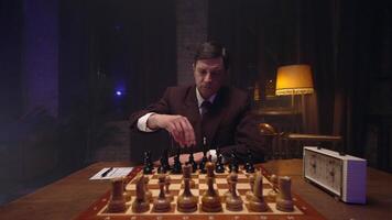 A man in a suit playing chess on a table video