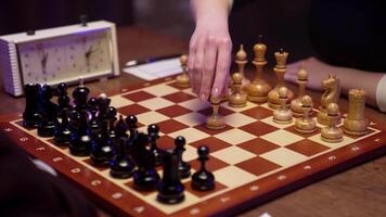 A person playing chess on a wooden board video