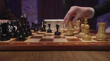 A person playing chess with a black and white chess piece video