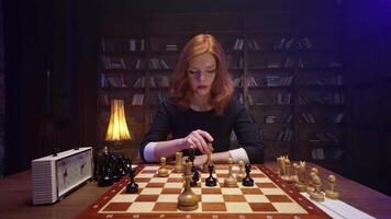 A woman playing chess in front of a bookcase video