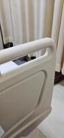 A bed for hospital patients. There are supports made of plastic and aluminum on the edge of the bed, useful as protection so that the patient does not fall out of bed. photo