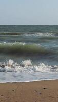Turquoise ocean waves crashing on a deserted sandy beach. The beautiful blue sky and the sound of the sea provide a relaxing and peaceful atmosphere video