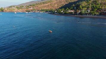 Woman travelling on kayak in ocean in Bali, Amed. Above view video