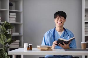 Medical Student Studying Medicine in Modern Classroom with Books and Stethoscope, Smiling and Engaged in Learning photo