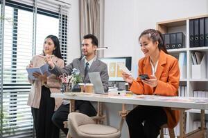 Program Developer Team Collaborates on UX UI Design in Modern Office Setting with Laptops and Mobile Devices photo