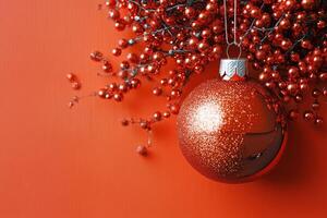 A Sparkly Red Christmas Ornament Hanging from a Branch, Ready for the Holiday Season photo