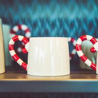 A row of mugs with candy canes on them photo
