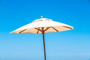 A white umbrella on a beach photo