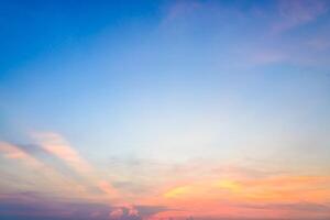 A sunset over the ocean with a boat in the distance photo