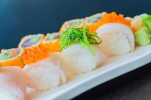 A plate of sushi with a variety of different types of sushi photo