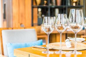 A table with four empty wine glasses on it photo
