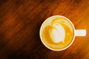 A cup of coffee with a heart shape in the foam photo