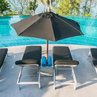 A black umbrella over a pool photo