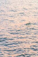 A man on a surfboard in the ocean photo