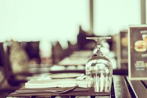 A table with a glass of wine and a menu photo
