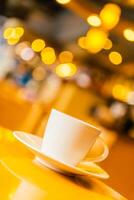 Coffee cup and saucer on a table in a restaurant photo