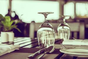 A table with empty wine glasses and silverware photo