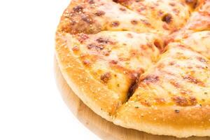 A pizza on a wooden board with cheese photo