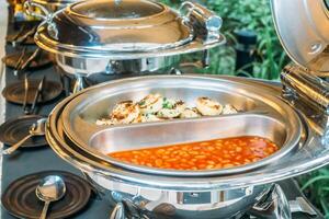 A buffet with food and silver dishes on it photo