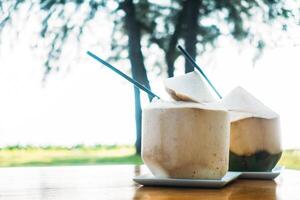 Two drinks sitting on a table photo