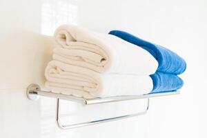 A towel rack with folded towels on it photo