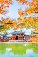 A beautiful asian temple surrounded by trees and water photo