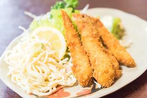 A plate of food with noodles and fish photo