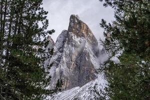 View of fog with mountain Geisler peaks in the Dolomites, Italy. photo
