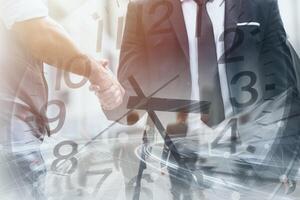 Business time fast moving speed working hours concept. Business people dealing project hand shaking overlay clock face. photo