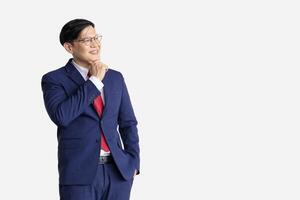 Businessman Asian model isolated on white background. Smart male in business suit expression think vision dream. photo