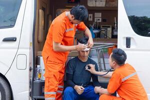 paramedic mobile car medical emergency team working in action help first aid save people life at accident site outdoors photo