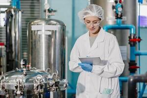 Professional QC staff work in science medical lab drinks beverage factory check record filter tank happy working photo