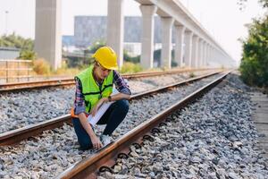 Engineer railway tracks construction service team working on site survey checking and maintenance inspection train track for safety photo