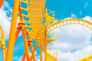 Rollercoaster railroad track high to the sky roll bend and twist for exciting fun at theme park photo