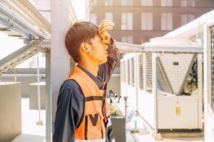Tired worker hand at forehead. engineer exhausted feel bad very sad fail. labor headache from hot weather. photo