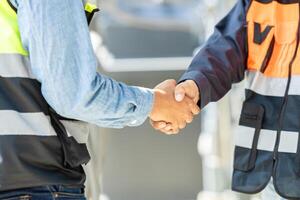 Engineer team dealing shaking hand together. Engineering cooperation group worker with construction manager teamwork working project successful. photo